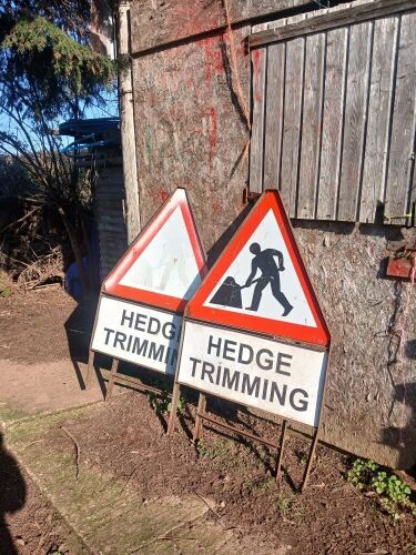 2 HEDGE TRIMMING SIGNS